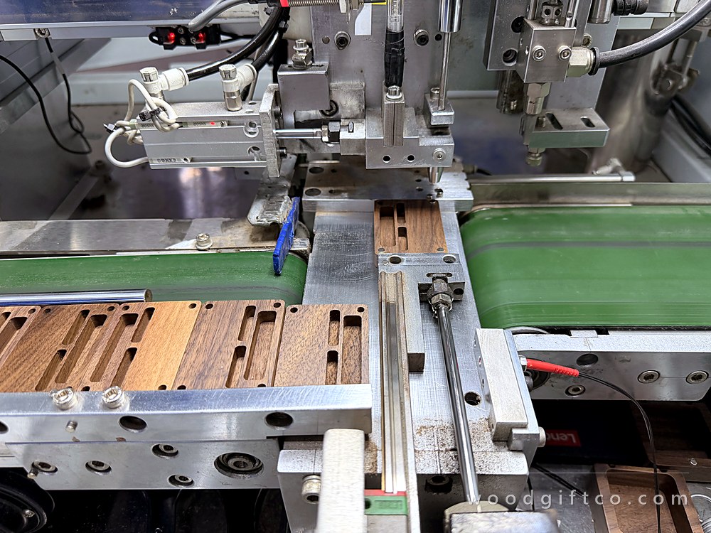 Automated magnet pressing line with walnut parts
